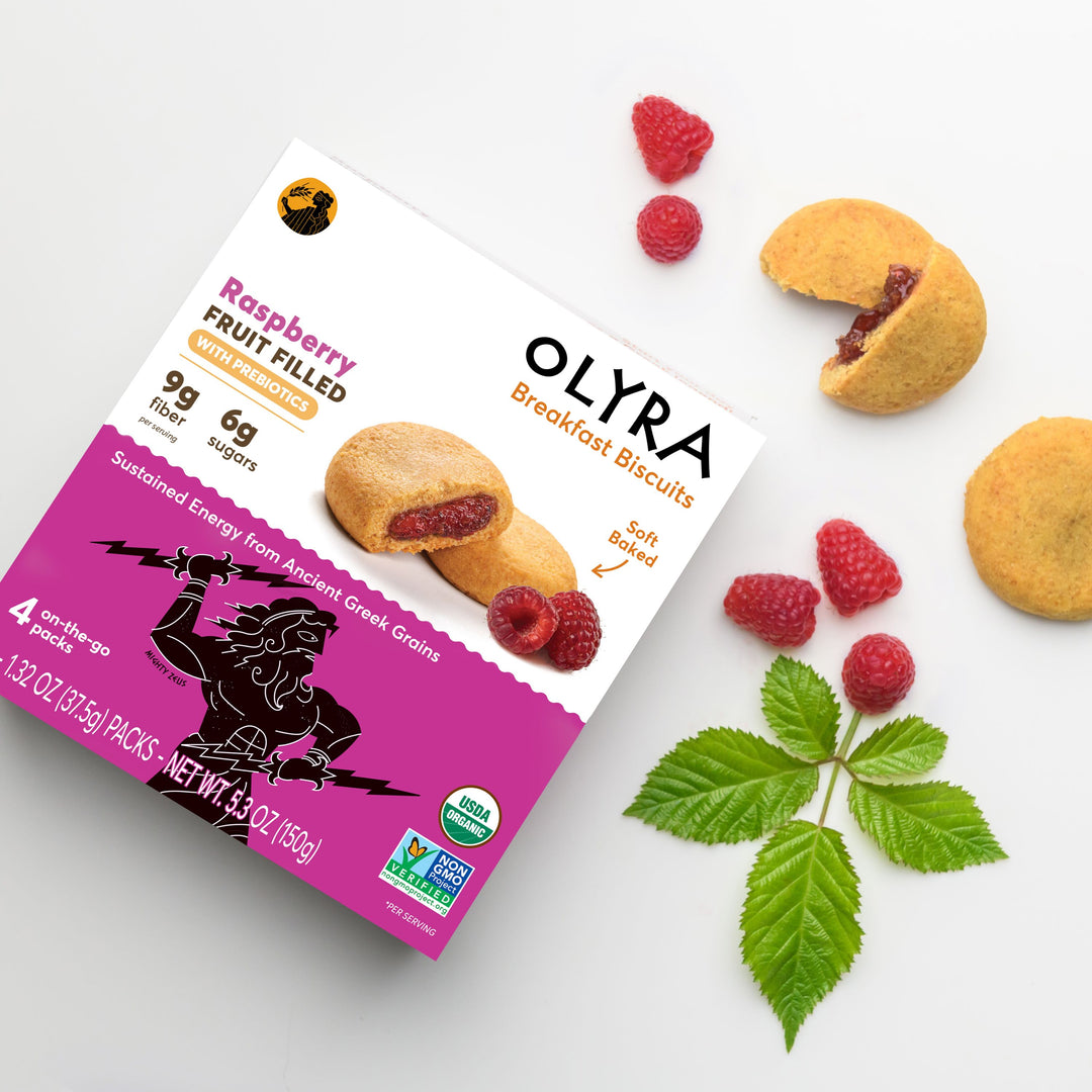 Olyra Raspberry Filled Breakfast Biscuits along with its box and 2 biscuits showcased with actual raspberries 