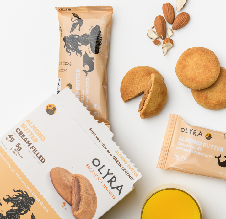 Olyra Almond Butter Cream Filled Breakfast Biscuits along with its box, internal plastic packaging showcased with almonds and butter