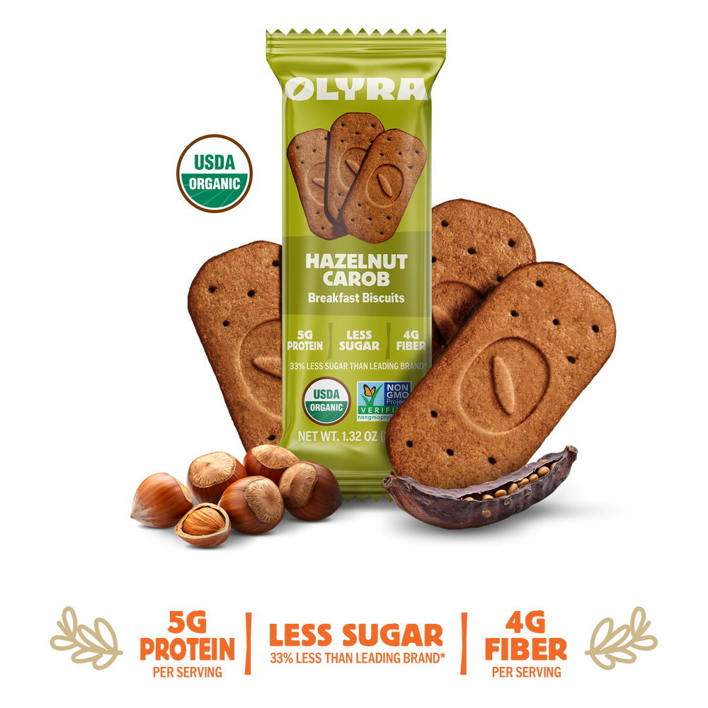 Olyra Hazelnut Carob Breakfast Biscuits packaging with cookies and nuts on a white background