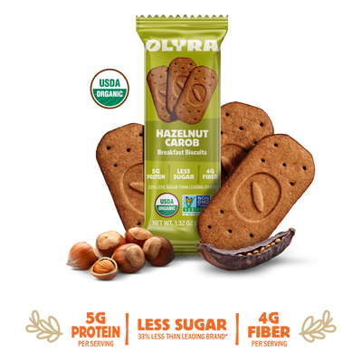 Olyra Hazelnut Carob Breakfast Biscuits packaging with cookies and nuts on a white background
