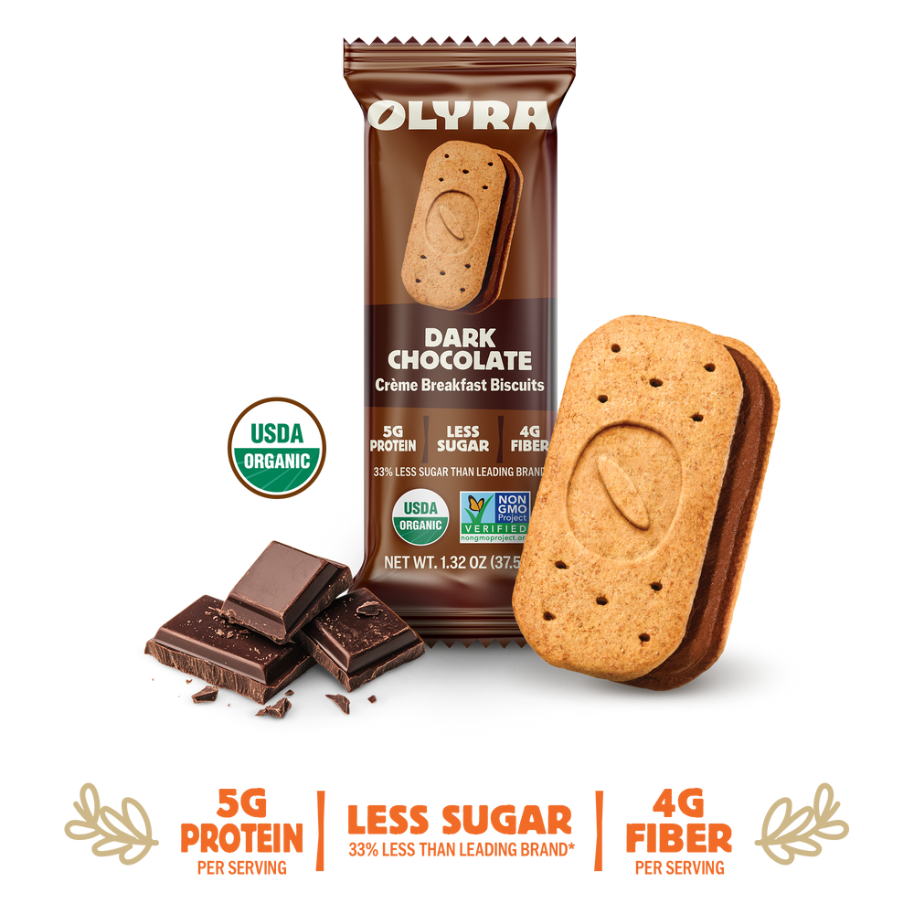 Olyra Dark Chocolate Creme Breakfast Biscuits packaging with a single biscuit and chocolate pieces on a white background.