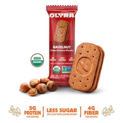 Olyra hazelnut cookies with packaging and nuts on a white background