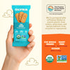 Olyra Fig Anise breakfast biscuits package held by a hand with product details on an orange background.