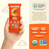 Olyra Dates & Honey soft baked bites packaging held by a hand with product details on the side.